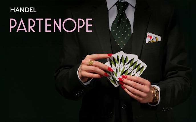 Person in suit holding playing cards with "Partenope" text.