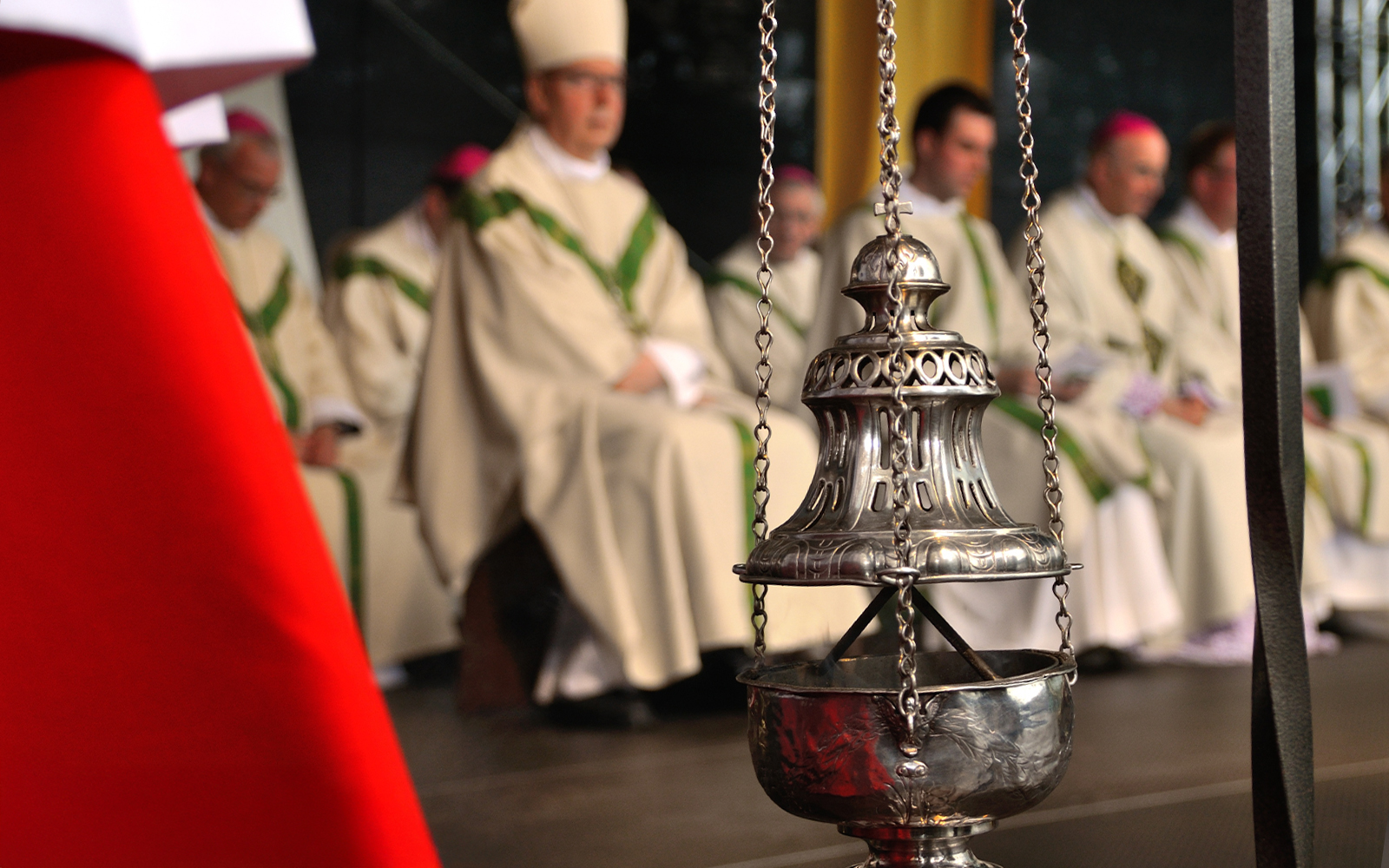 Incense burner swinging during a church service in a historic cathedral.