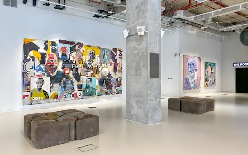 Collage art and portraits in Andy Warhol: The Glam Factory exhibition space.