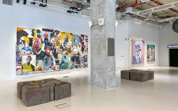 Collage art and portraits in Andy Warhol: The Glam Factory exhibition space.