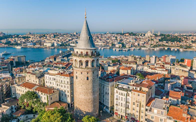 Galata Tower overlooking Istanbul cityscape and Bosphorus River.