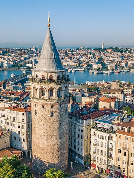 Galata Tower overlooking Istanbul cityscape and Bosphorus River.