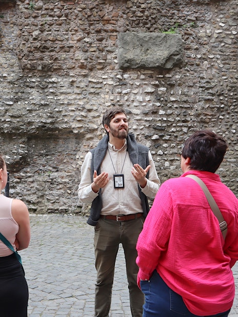 Guide explaining history to tourists at Castel Sant'Angelo, Rome.