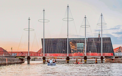 Circle Bridge over Copenhagen Harbor with cityscape backdrop.