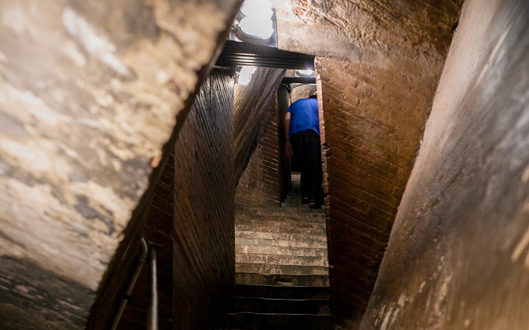 Inner stairs of Florence Cathedral dome with a person ascending.