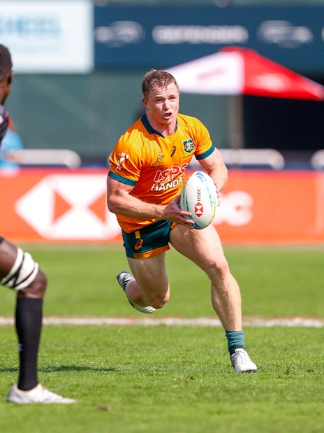 Rugby players in action during Emirates Dubai 7s match, Dubai stadium.