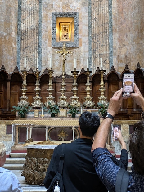Visitors photographing the altar inside the Pantheon in Rome.