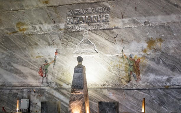 Slanic Prahova Salt Mine interior with Roman carvings and statue, near Bucharest.