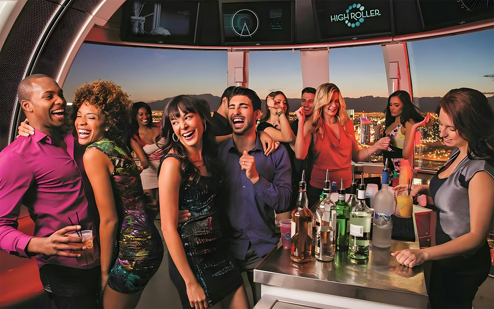 Guests celebrating at High Roller Observation Wheel in Las Vegas with city views.