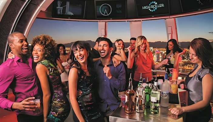 Guests celebrating at High Roller Observation Wheel in Las Vegas with city views.