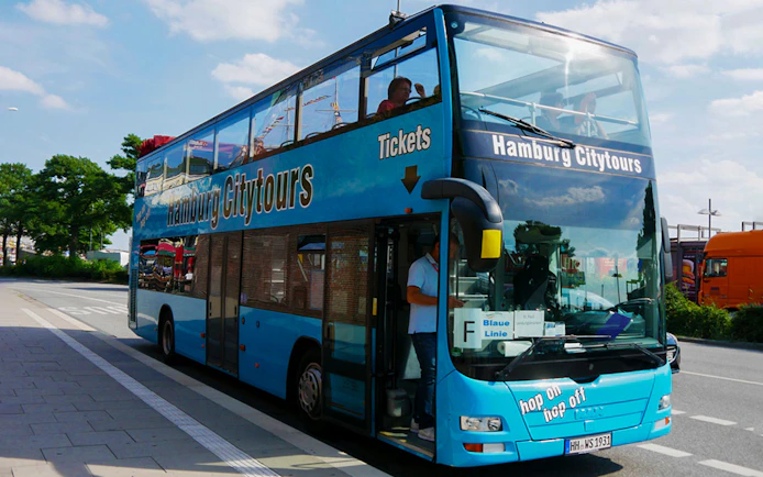 Hop-on hop-off bus for Hamburg City Tours parked on a street.