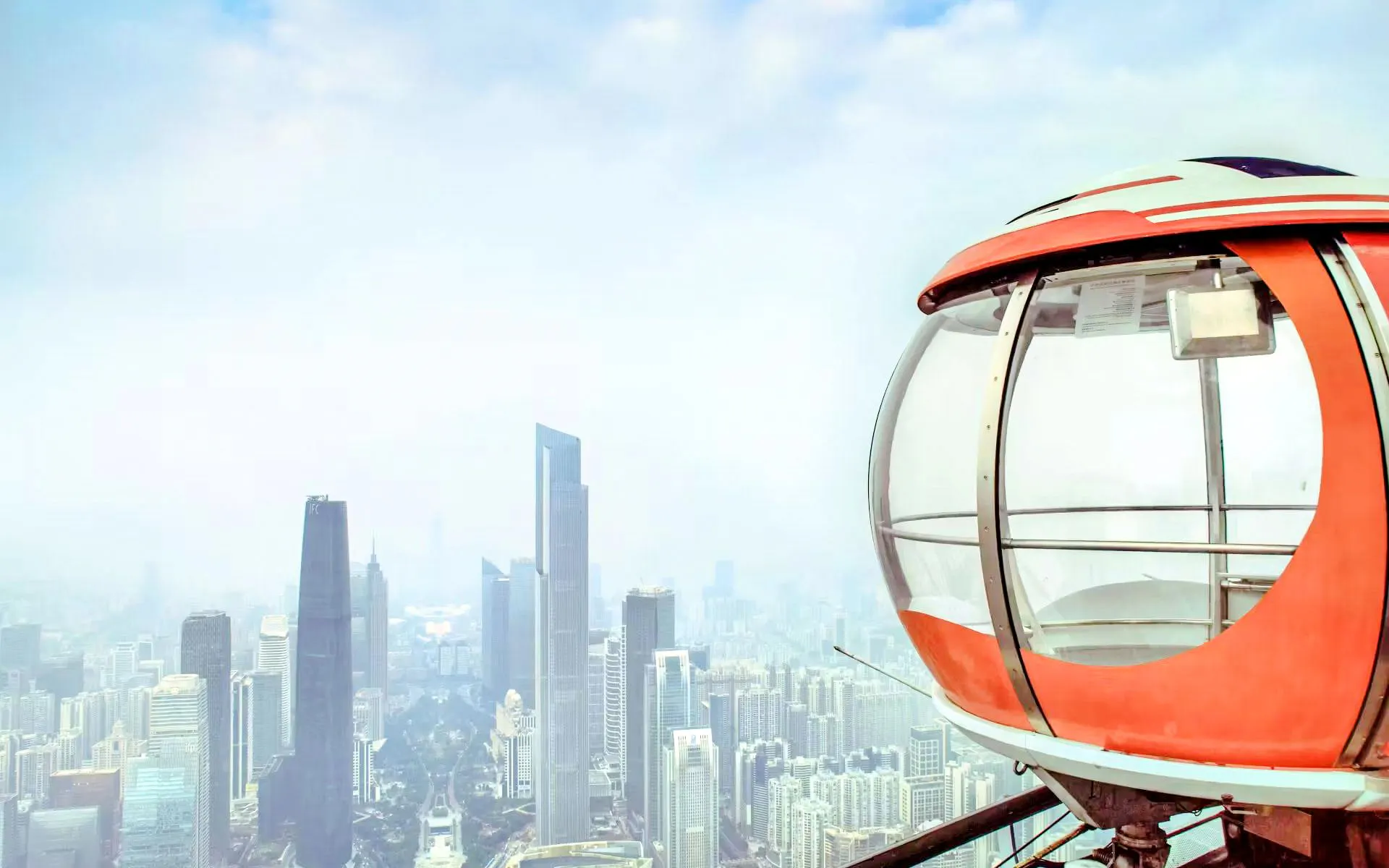 Canton Tower bubble tram with Guangzhou skyscrapers in the background.