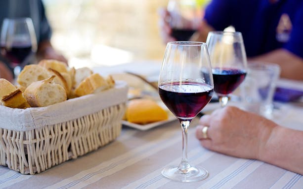 Wine glasses and bread on a table during Krakow Vistula River cruise and walking wine tour.