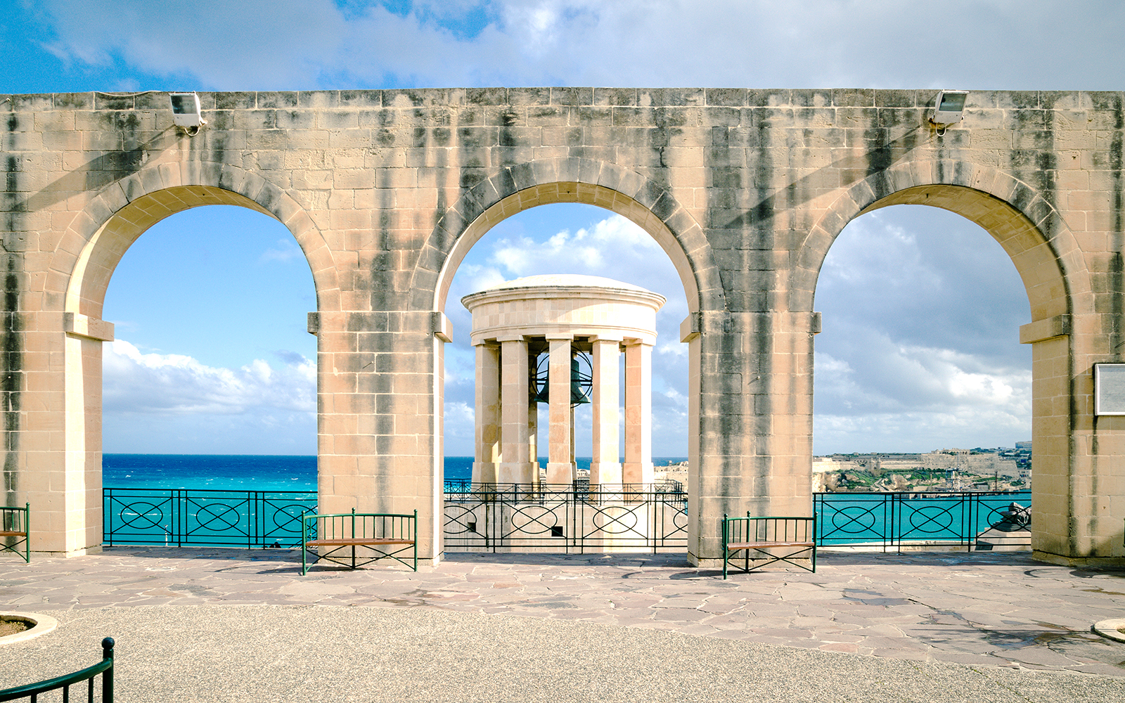 Upper Barrakka Gardens view of Grand Harbour, Valletta, Malta, showcasing historic architecture.