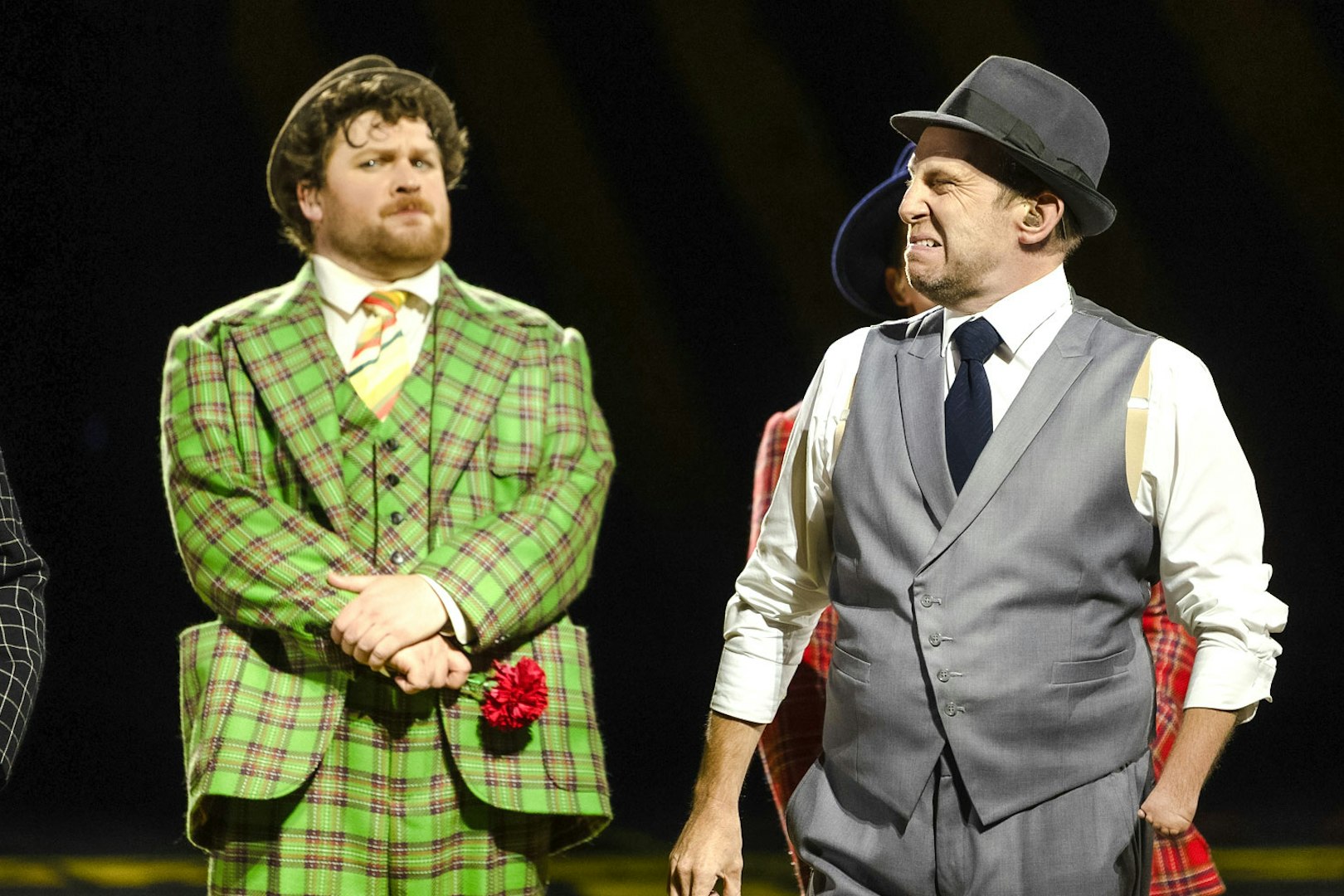 Actors in colorful suits performing "Guys & Dolls" on Sydney Harbour stage.