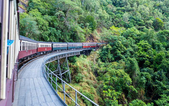 Kuranda scenic railway passing through lush green forests in Australia.