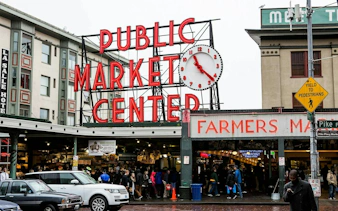 Pike Place Market entrance with clock and crowd, Seattle Harbor of Secrets game location.