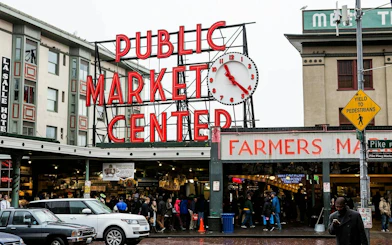 Pike Place Market entrance with clock and crowd, Seattle Harbor of Secrets game location.