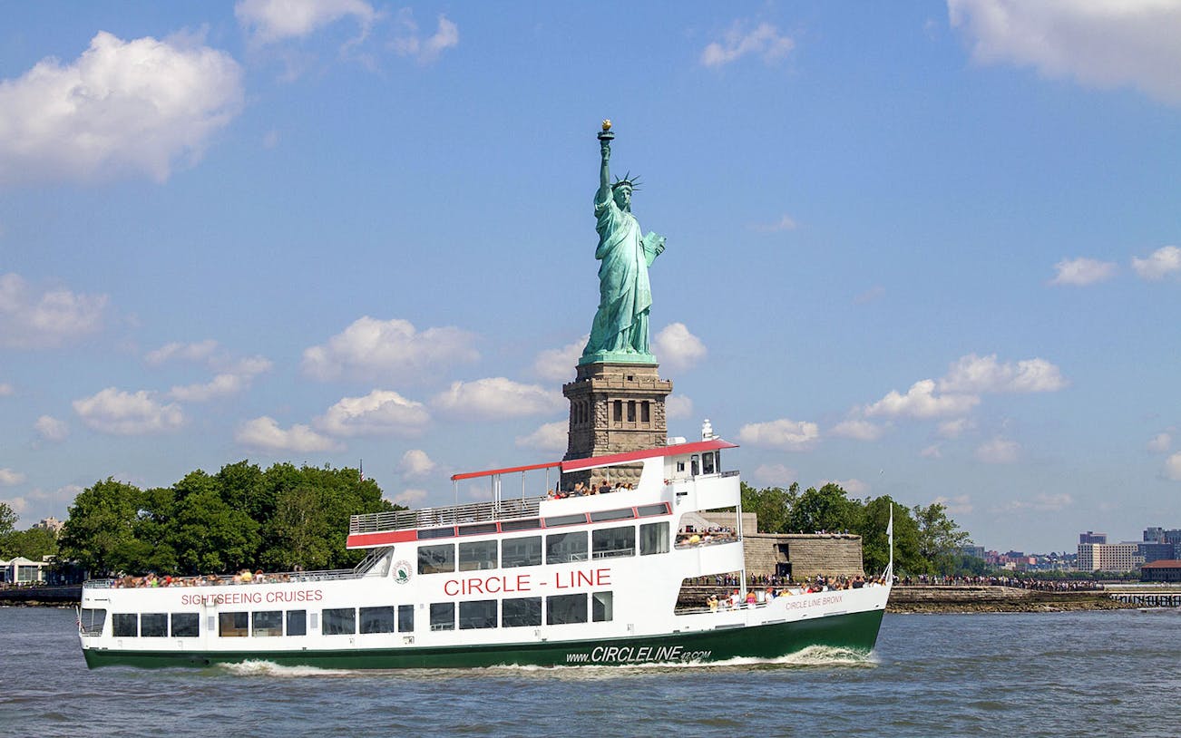 Circle Line cruise passing the Statue of Liberty in New York City.
