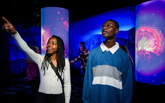 Visitors exploring an interactive exhibit at Niagara Takes Flight, Canada.
