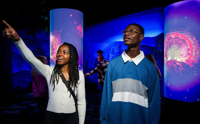 Visitors exploring an interactive exhibit at Niagara Takes Flight, Canada.