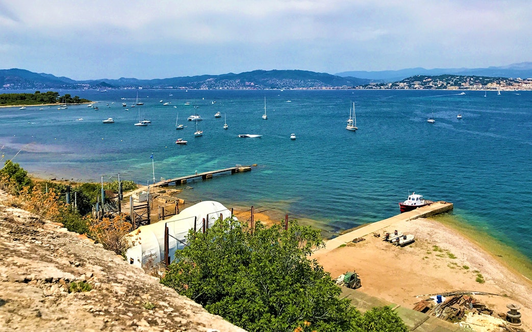 Ferry dock and boats at Ste. Marguerite Island, view from Cannes across the sea.
