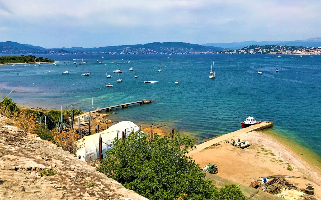 Ferry dock and boats at Ste. Marguerite Island, view from Cannes across the sea.