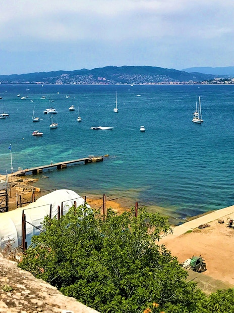 Ferry dock and boats at Ste. Marguerite Island, view from Cannes across the sea.