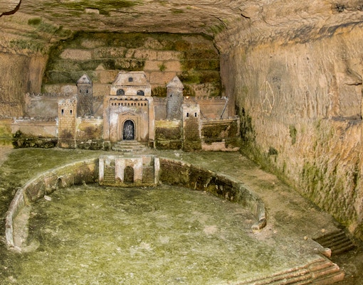 Port-Mahon Corridor model in Paris Catacombs, depicting a fortress carved into stone walls.