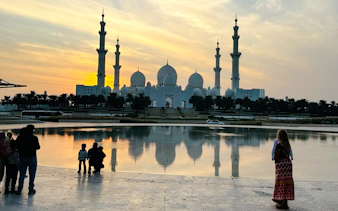 Sheikh Zayed Grand Mosque at sunset during Abu Dhabi night city tour.