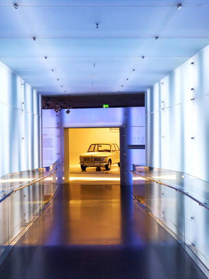 BMW Museum hallway leading to vintage car exhibit.