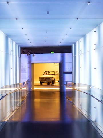 BMW Museum hallway leading to vintage car exhibit.