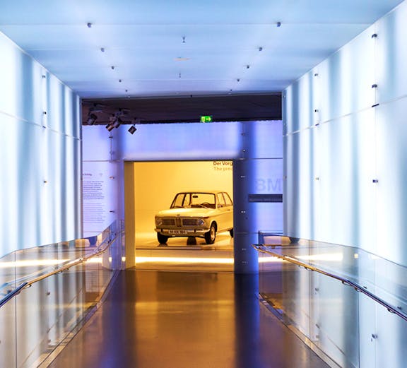 BMW Museum hallway leading to vintage car exhibit.