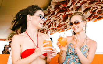 Guests enjoying drinks on a Pattaya luxury yacht cruise.