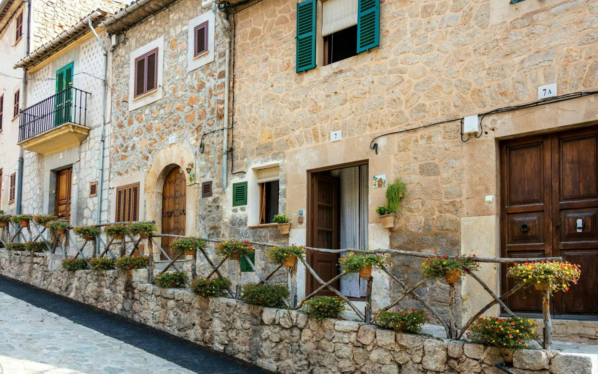 Stone buildings with wooden shutters in Valldemossa, Mallorca.