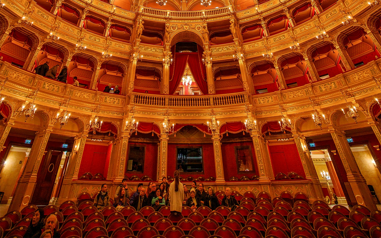 Guests with tour guide inside the ornate Hungarian State Opera House.