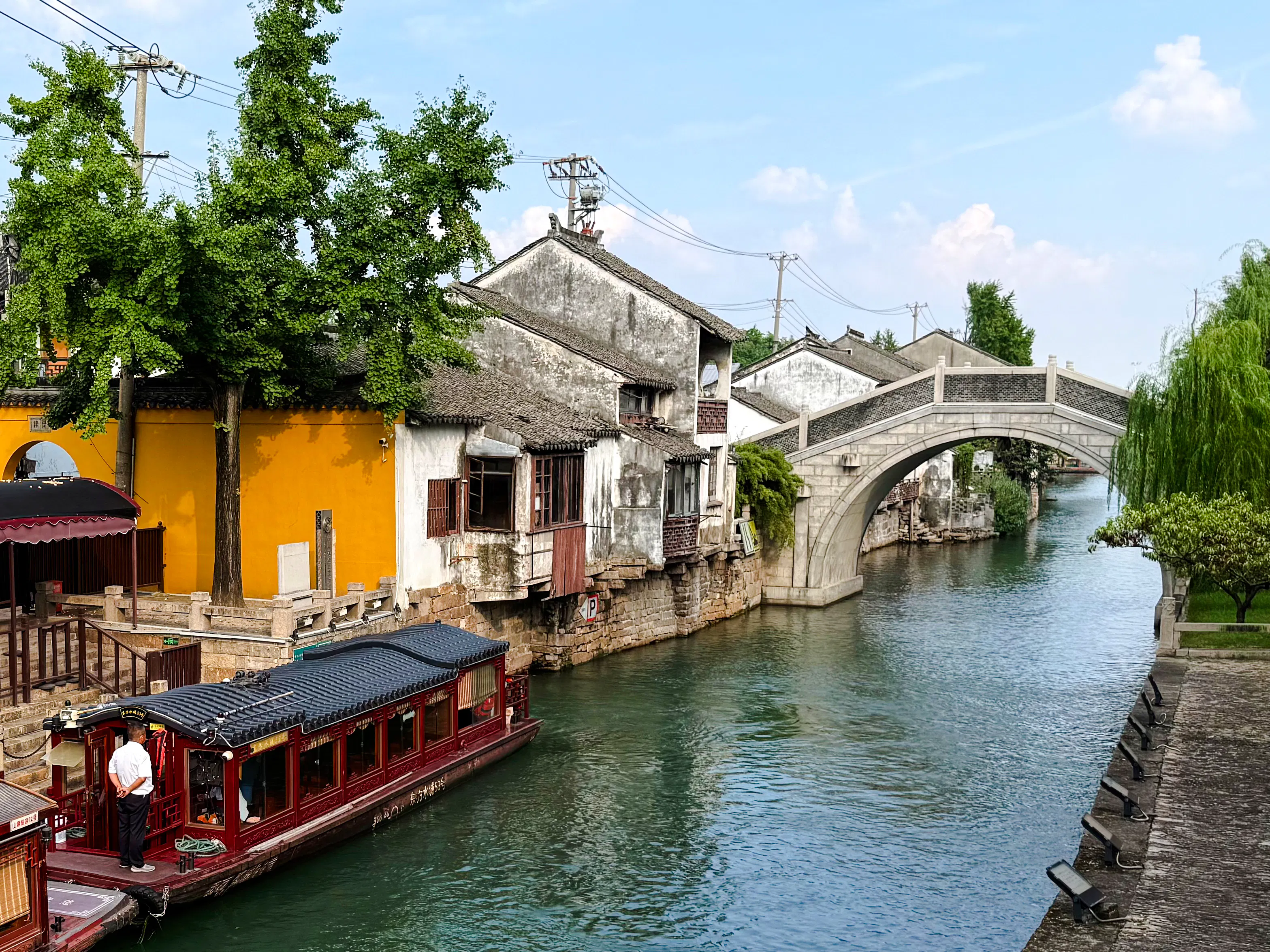 Traditional boat on canal near stone bridge in a historic water town, Shanghai.