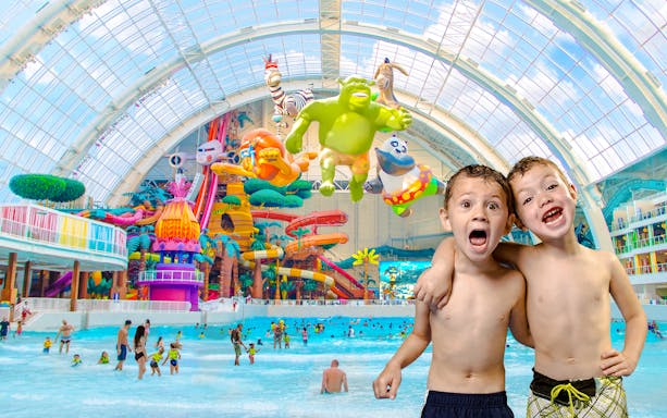 Children enjoying the wave pool at DreamWorks Water Park with colorful slides and characters.