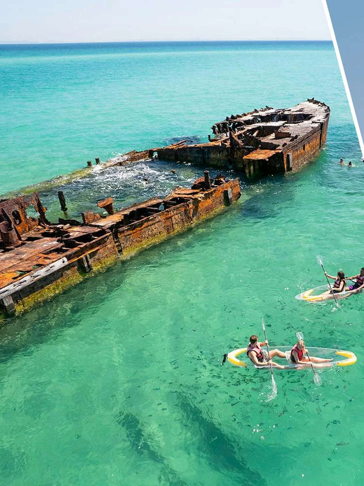 Aerial view of kayakers near shipwreck at Moreton Island and climbers on Story Bridge, Brisbane.