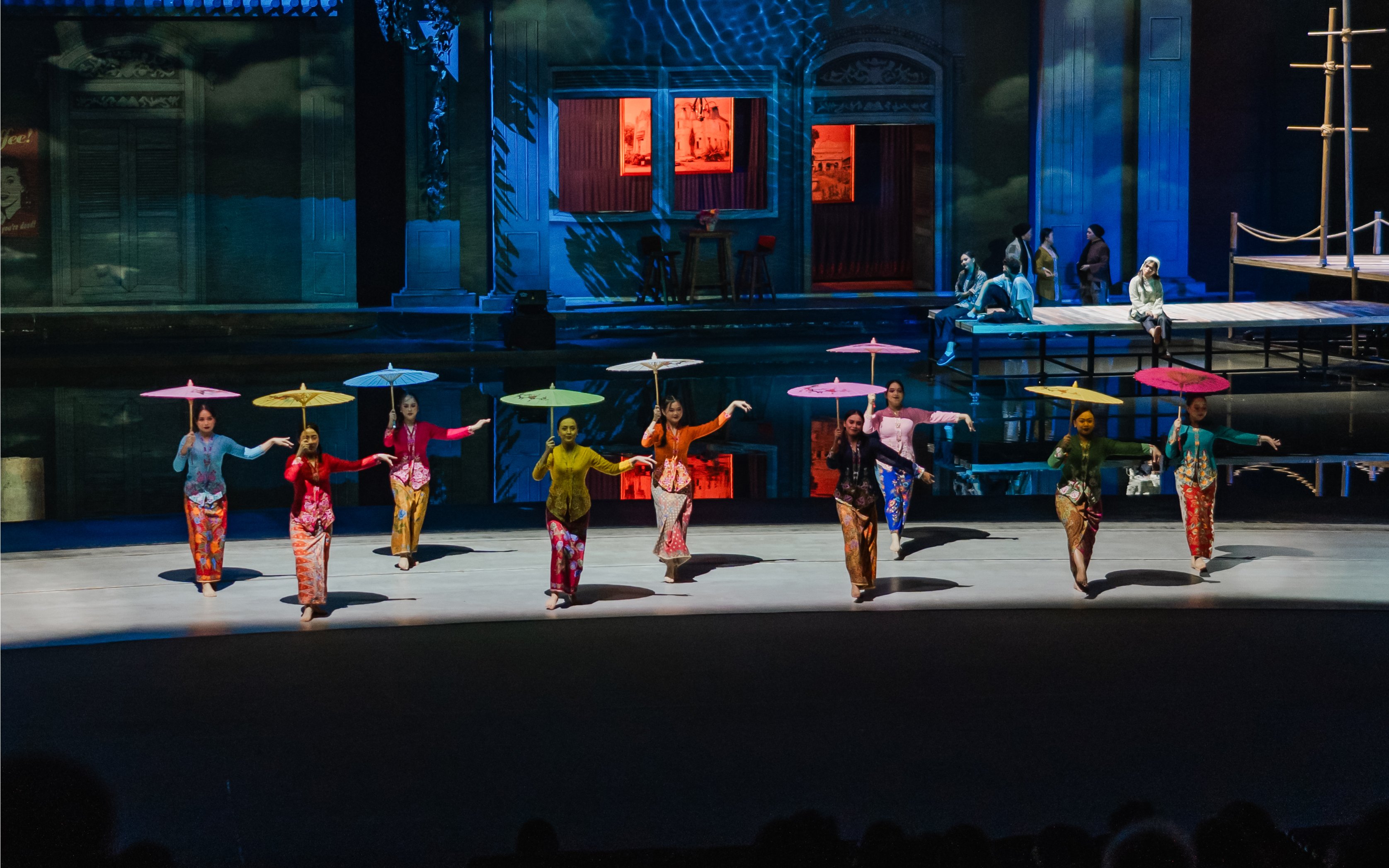 Women with umbrellas performing at The Legacy of a Generation Show.