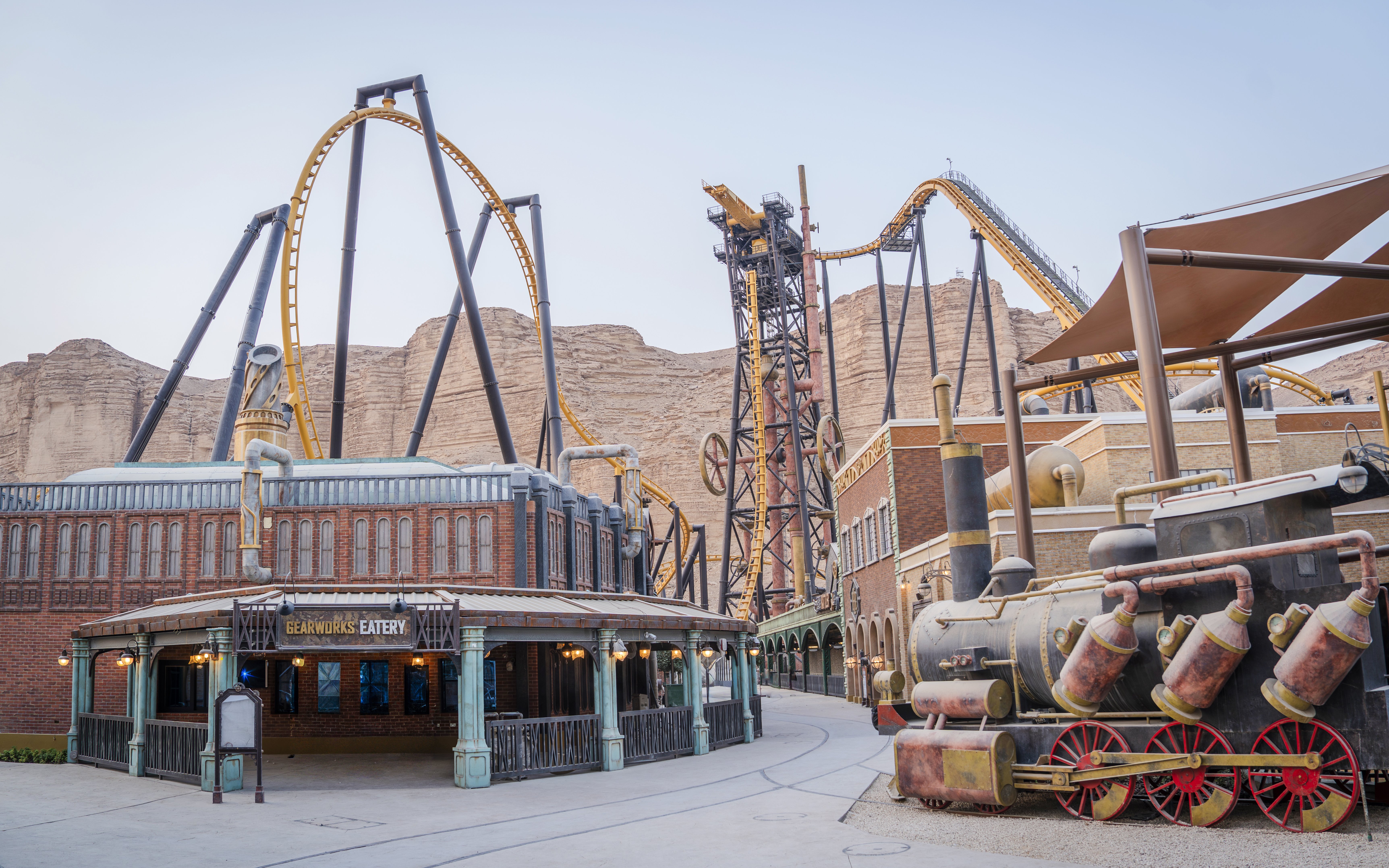 Roller coaster and steam train at Steam Town, Six Flags Qiddiya City.