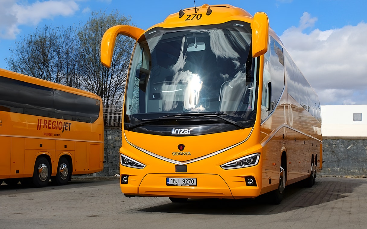 Yellow RegioJet bus for one-way tickets from Prague Airport to Prague City Center.