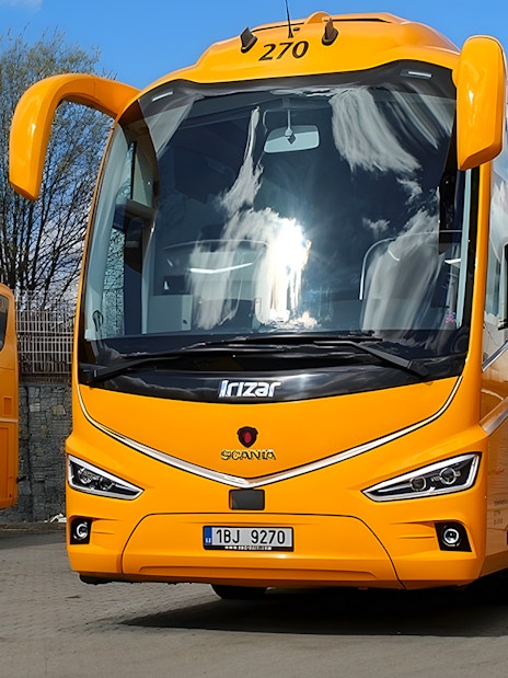Yellow RegioJet bus for one-way tickets from Prague Airport to Prague City Center.