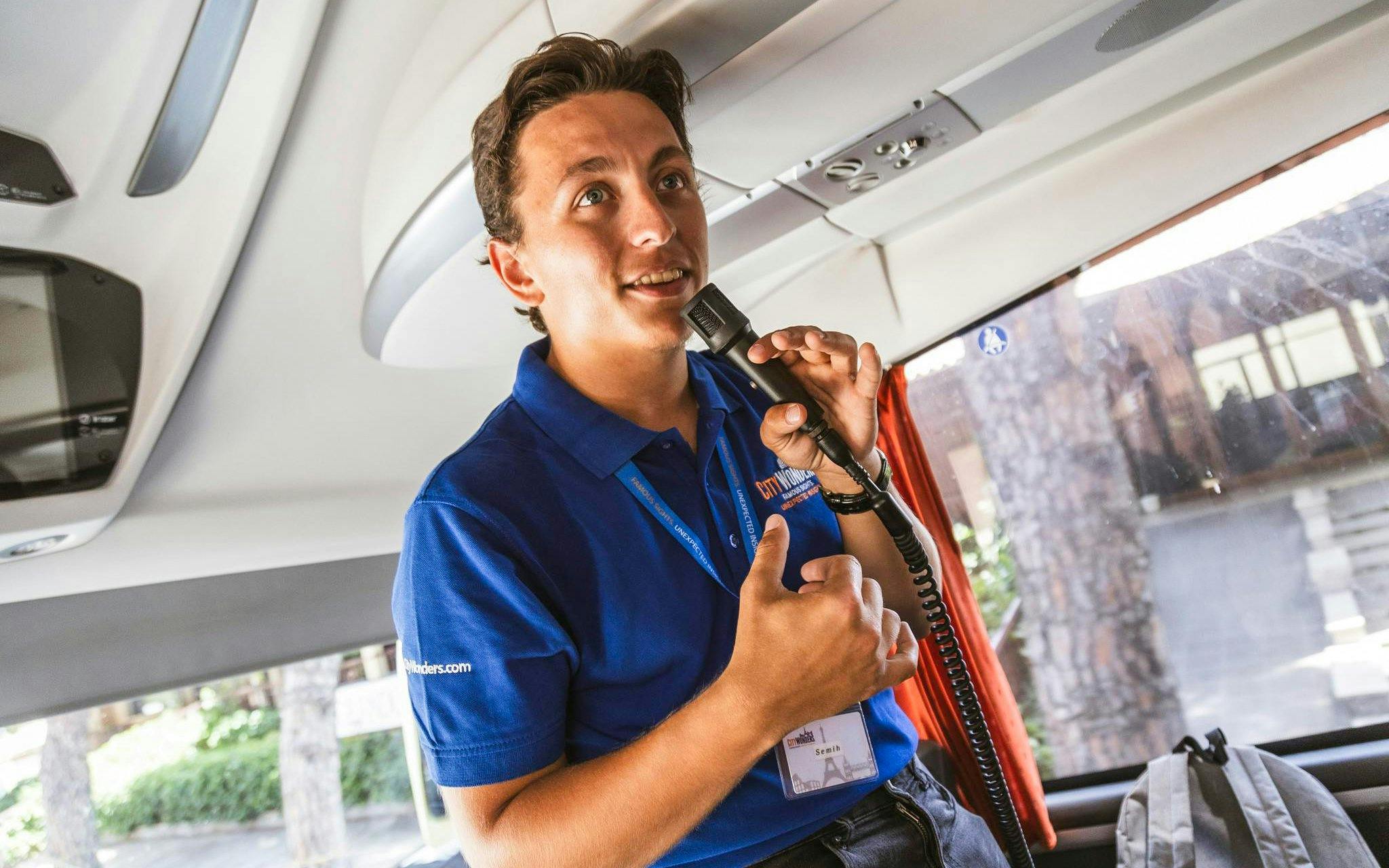 Guide speaking on a coach during Siena and San Gimignano day trip.