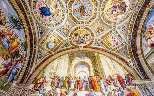 Vatican Museums' ornate ceiling and frescoes in the Raphael Rooms, showcasing Renaissance art.