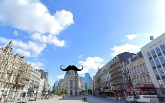 Brussels cityscape with historic buildings, part of Detective X Rescue game.