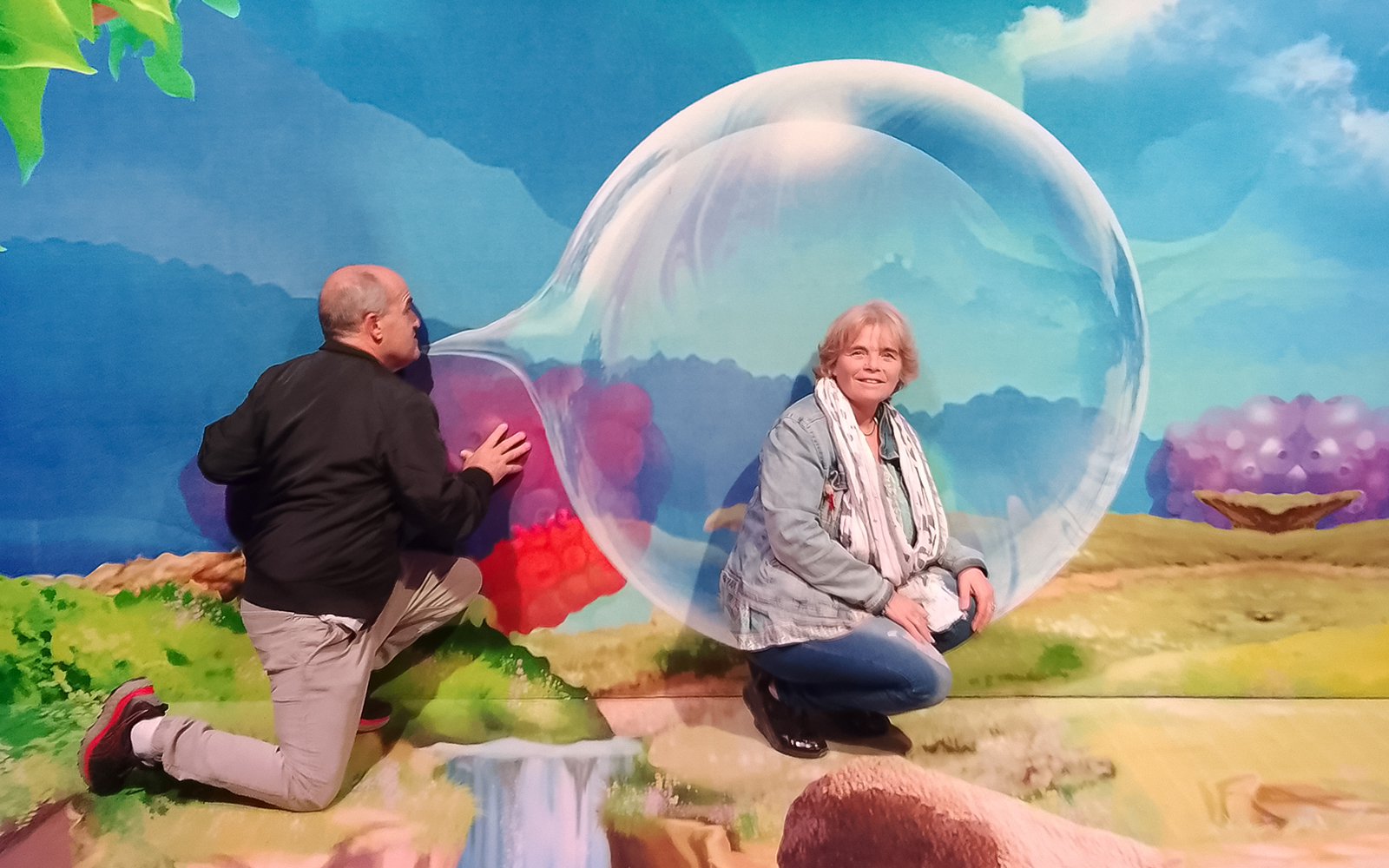 Guests interacting with a large bubble display inside Bubble Planet Berlin.