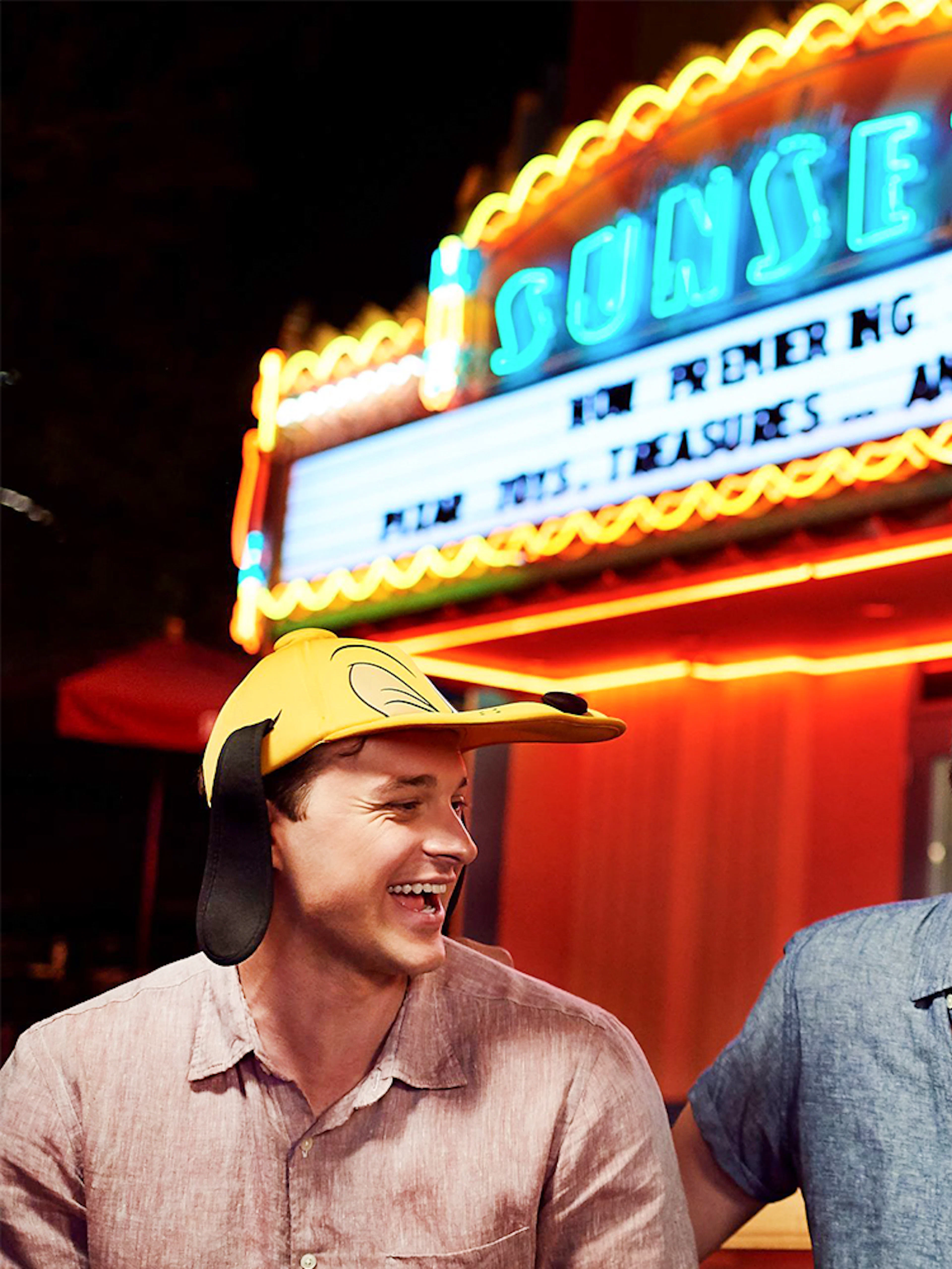 Friends laughing outside a movie theatre at Disney's Hollywood Studios, Orlando.