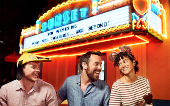 Friends laughing outside a movie theatre at Disney's Hollywood Studios, Orlando.