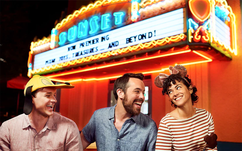 Friends laughing outside a movie theatre at Disney's Hollywood Studios, Orlando.